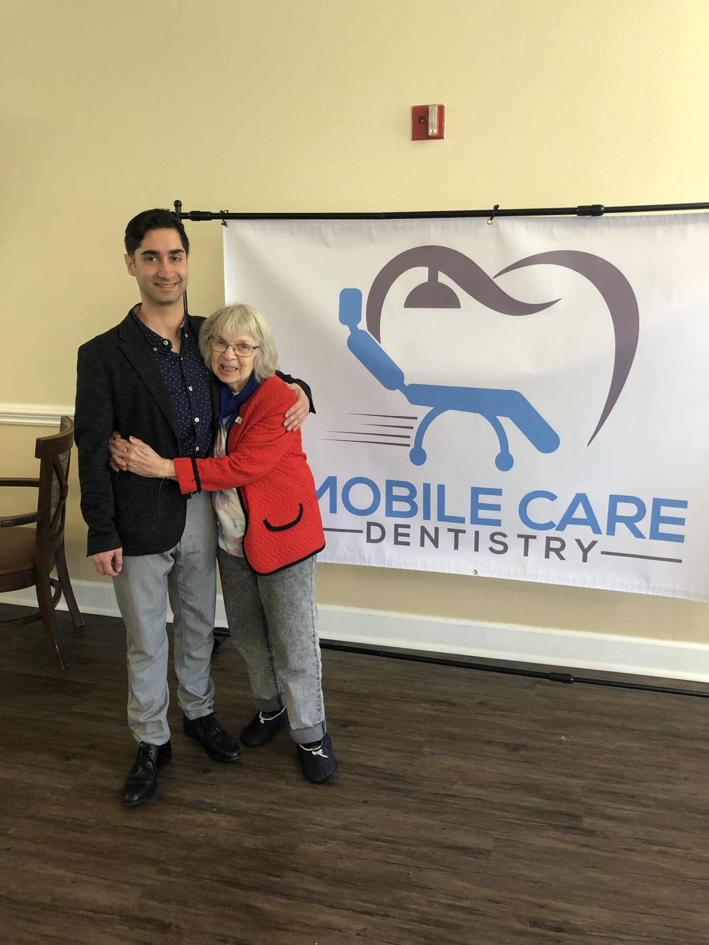 Dr. Koo Karimi with a longtime patient at a community dental day