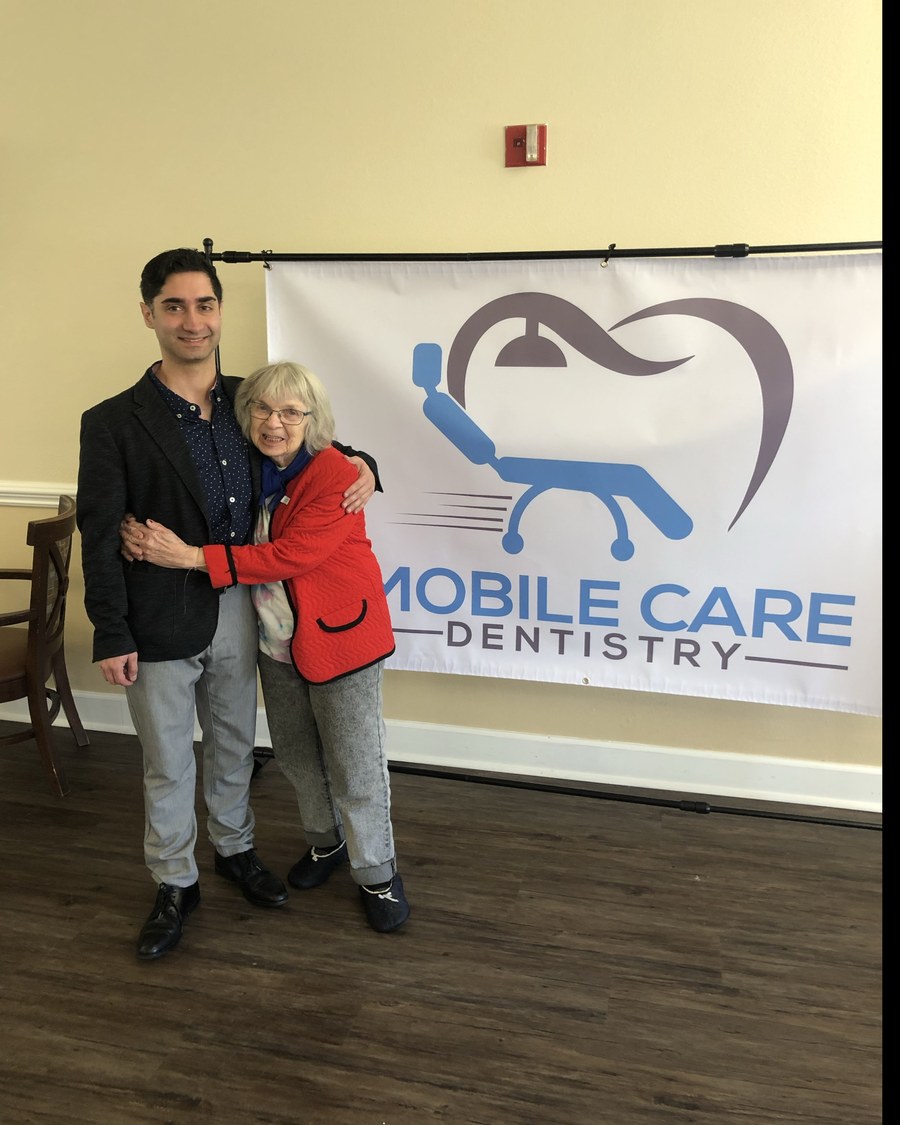 Dr. Koo Karimi, DDS with a longtime patient at a community dental day